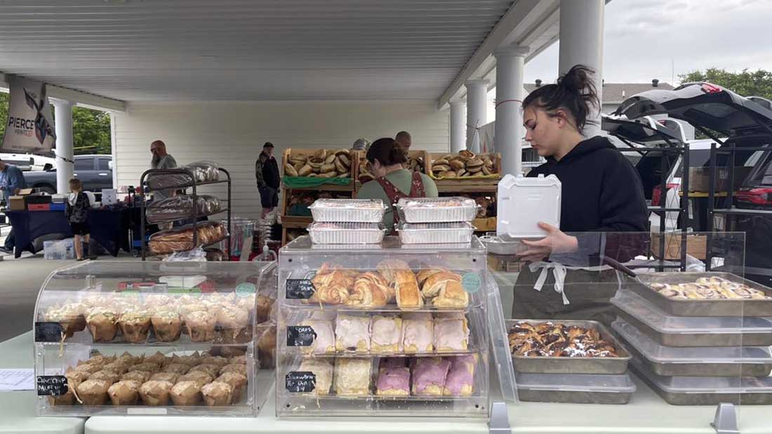 Busy Independence Farmers Market scene with vendors and shoppers